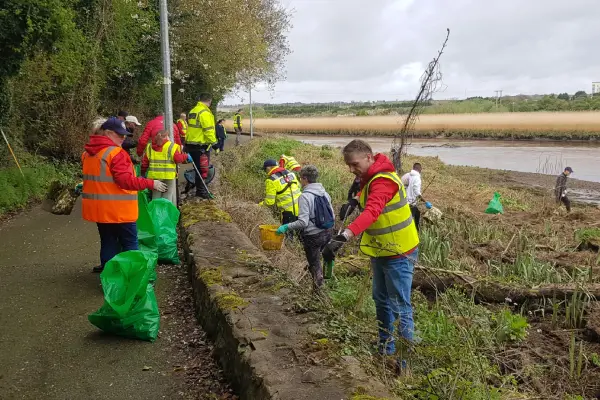 volunteers cleaning up an area