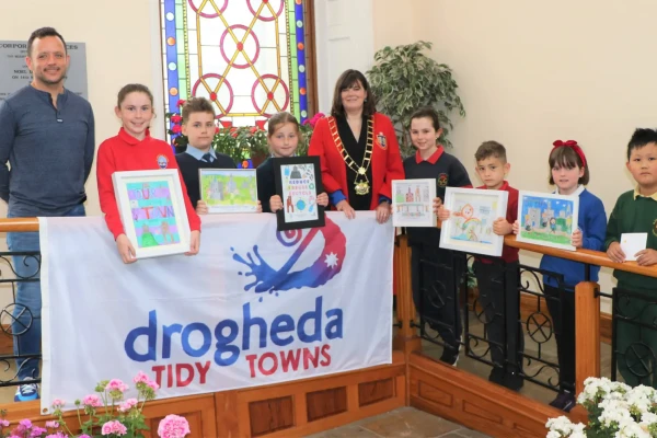 kids holding art they drew